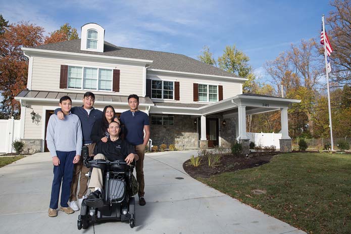 The Avila family poses for a photo outside their new smart home