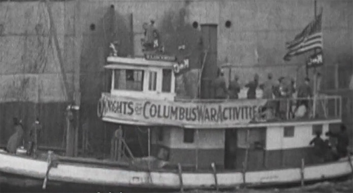 Docked boat with a banner 'Knights of Columbus War Activities' during world war 1.