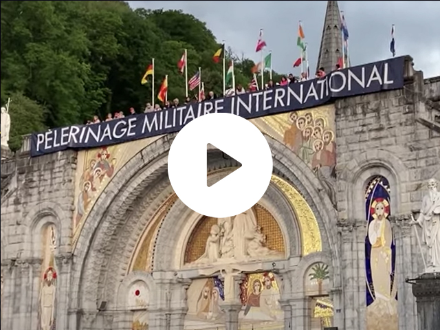 Church with Warriors to Lourdes banner draped over